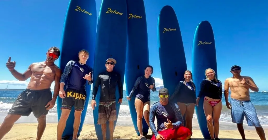 Group of surfers catching waves during a mixed group lesson