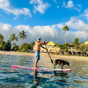 Person receiving private stand-up paddleboard instruction on calm water
