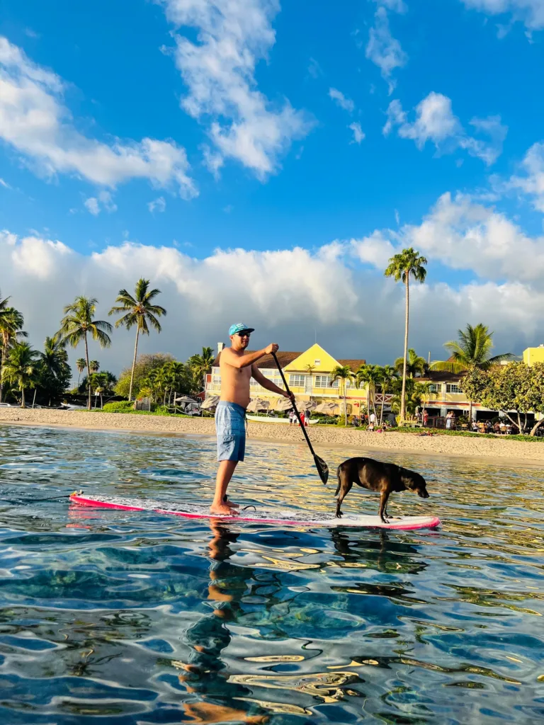 Person receiving private stand-up paddleboard instruction on calm water
