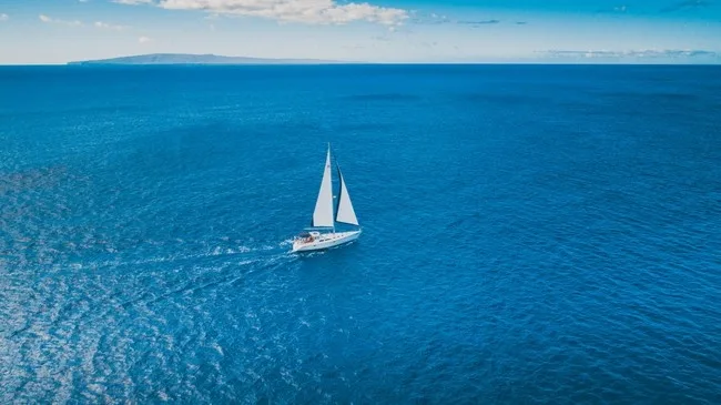Snorkelers exploring coral reefs from Monohull Nova sailboat