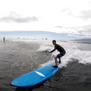 Instructor giving private surf lesson on Maui beach