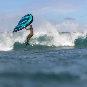 Wave riding lesson with instructor guiding a beginner surfer