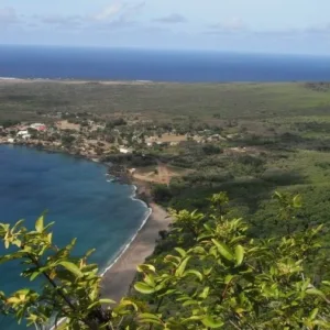 Small boat cruising along a scenic island coastline during a mini tour