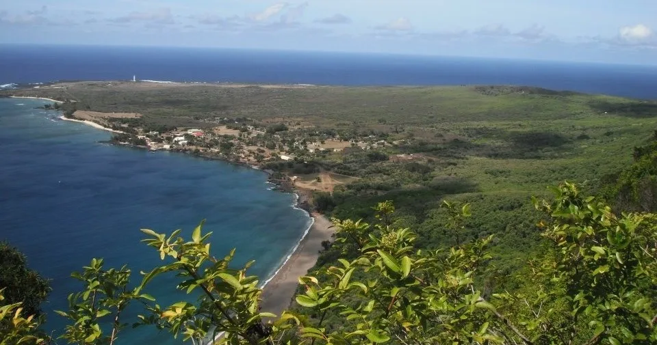 Small boat cruising along a scenic island coastline during a mini tour