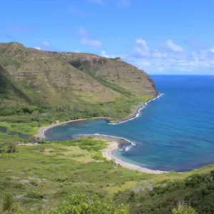 Hikers trekking along lush trail during Halawa hike in Hawaii