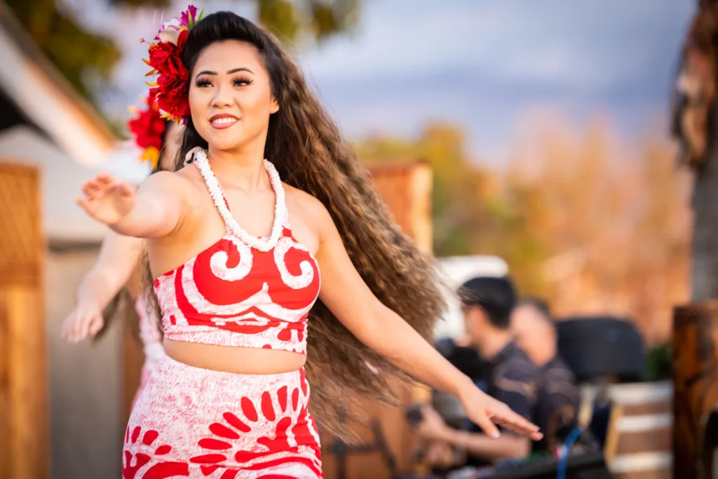 Audience seated in general seating area at Hawaiian luau event