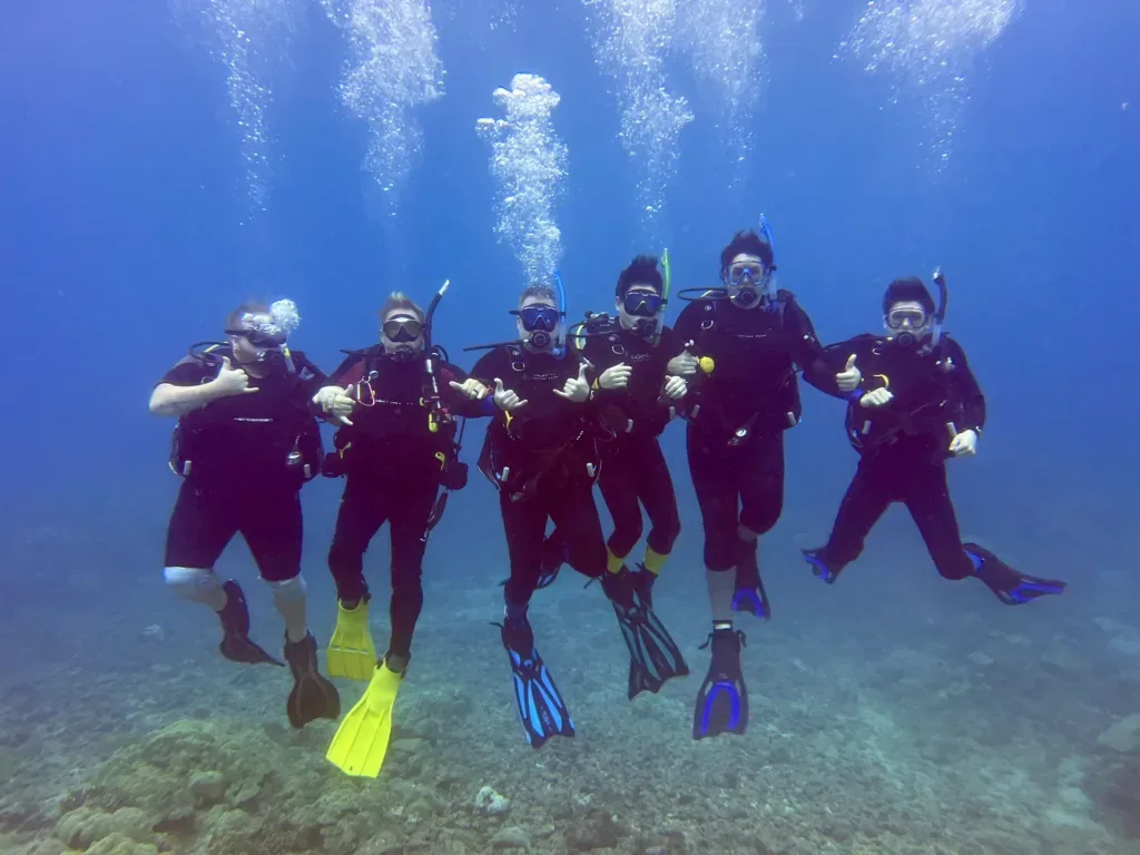 Scuba diver exploring colorful coral reefs underwater