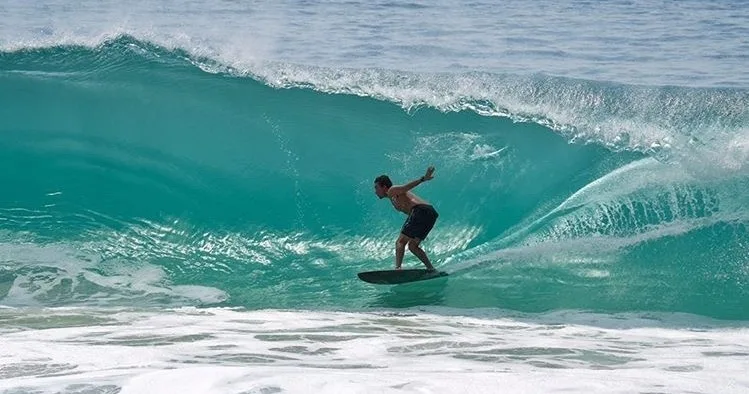 Instructor guiding student during private surf lesson