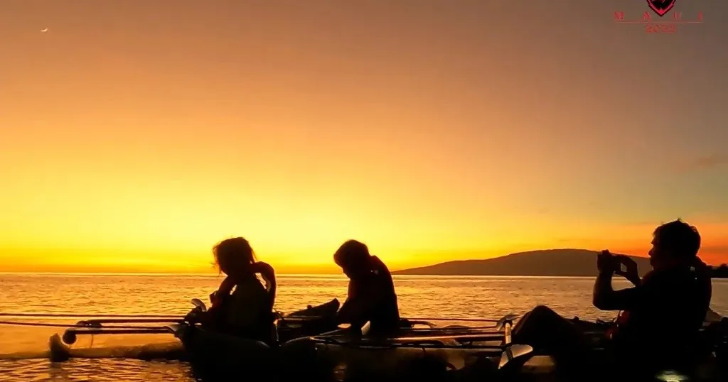 Clear kayak gliding at sunset over Olowalu waters