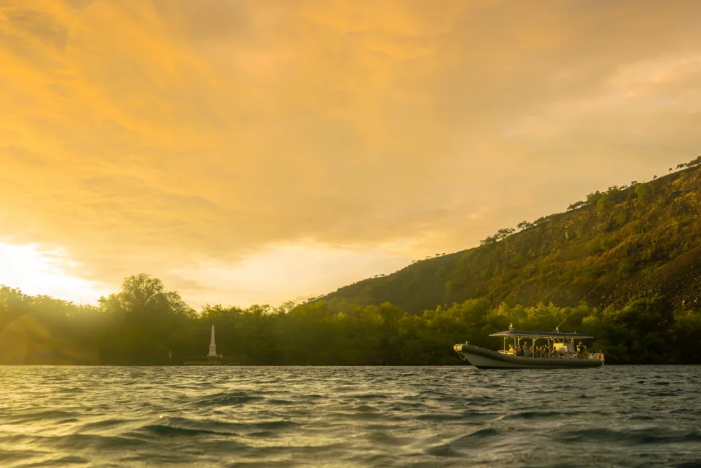 Super-raft boat cruising at sunset along Kona coastline