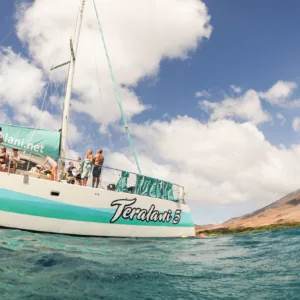 Snorkelers exploring coral reefs during West Maui sail tour