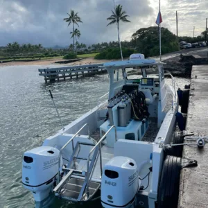 Scuba divers exploring underwater reefs on South Island Kauai