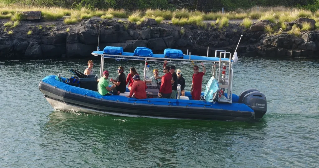 Snorkelers swimming among colorful fish near Kona coast