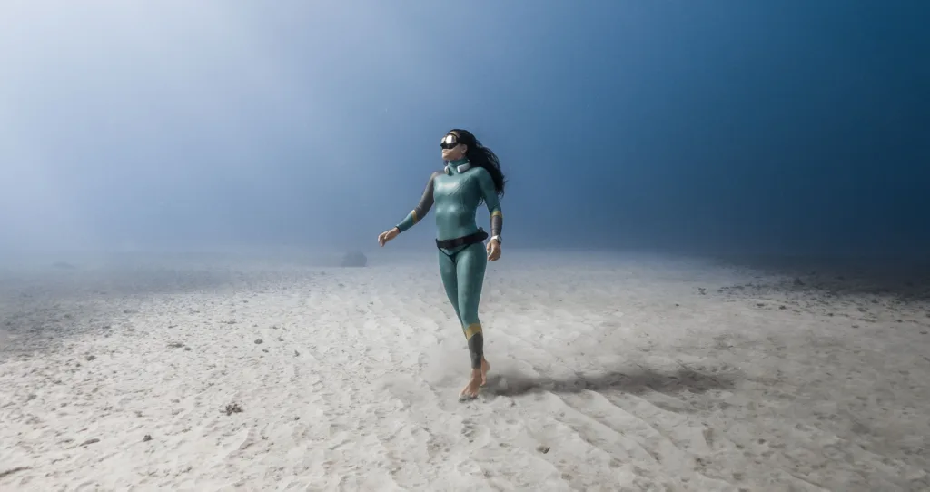 Highly skilled divers performing complex underwater maneuvers