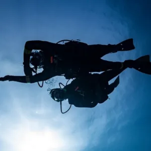 Scuba divers learning underwater navigation skills in Kona