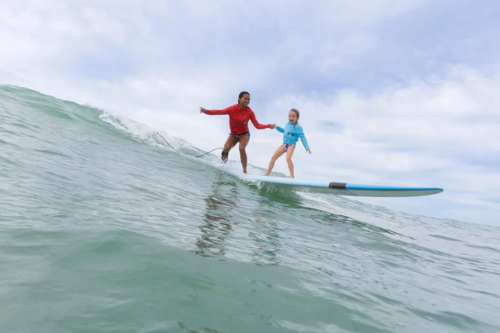 Surfer catching waves at Ala Moana beach in Oahu