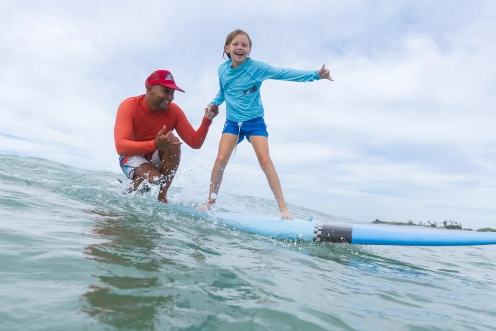 Beginner surfers catching waves at Kapolei beach
