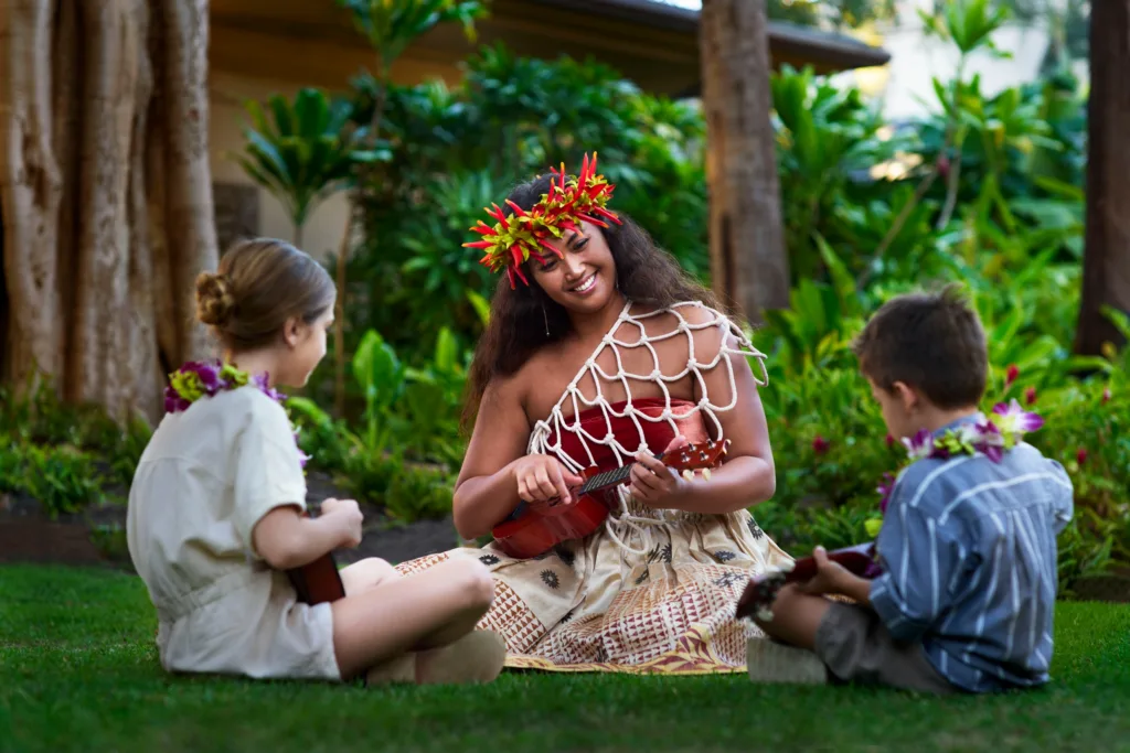 Guests seated in traditional ohana style at luau