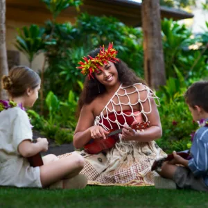 Guests seated in traditional ohana style at luau