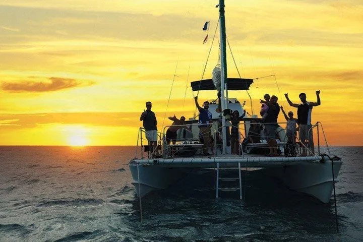 Small group enjoying Waikiki sunset cruise with drinks