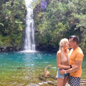 Hikers trekking along lush Hana trail through forest