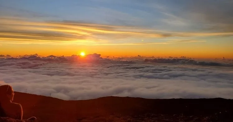 Explorers hiking rugged terrain in West Maui mountains