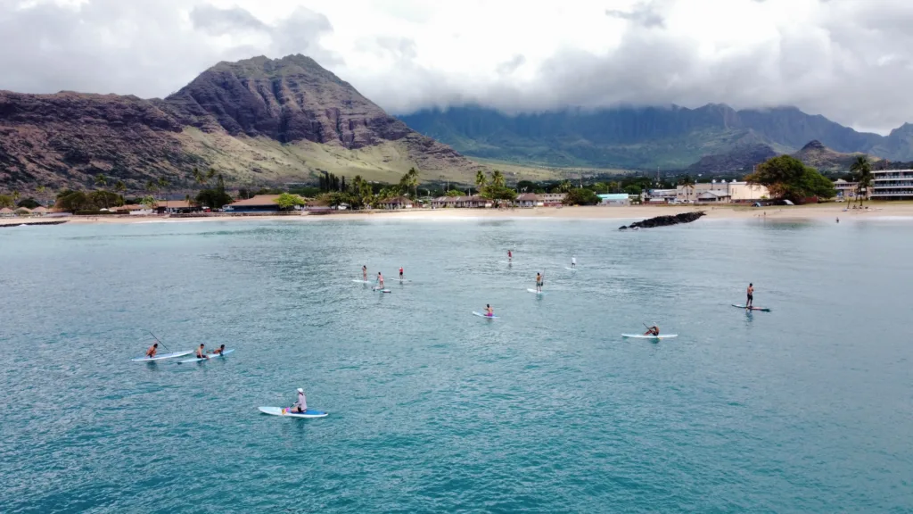 Stand up paddleboarders learning at Pokai Bay calm waters