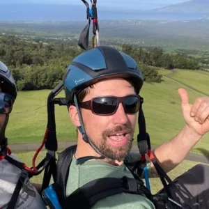 Tandem paragliders launching from mountain during flight
