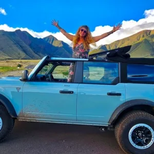 Convertible Bronco driving along Maui's scenic Hana road