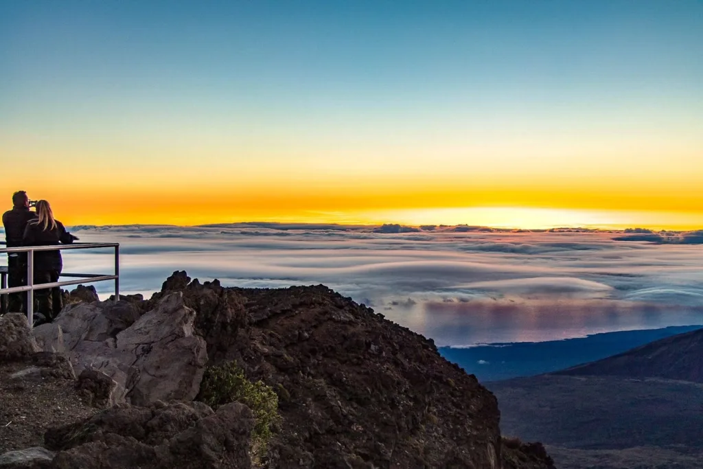 Tour group watching sunrise over Haleakalā crater