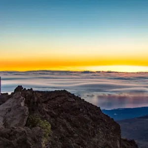 Tour group watching sunrise over Haleakalā crater