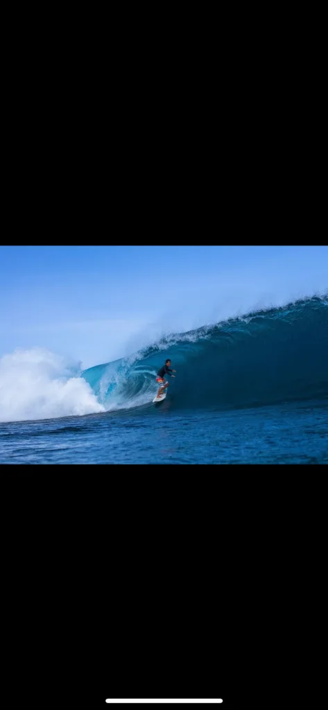 Experienced instructor guiding private advanced surf lesson