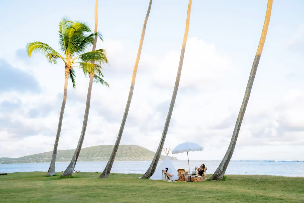 Couple enjoying luxury picnic setup on sandy beach
