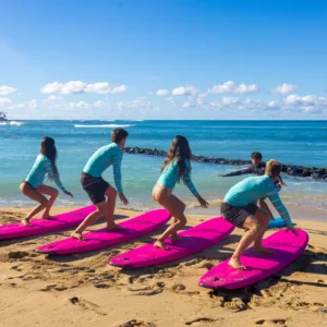 Large group learning to surf on sunny island beach
