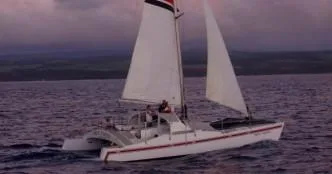 Boat cruising during golden sunset over ocean