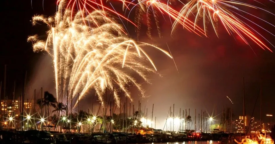 Couple watching fireworks during romantic sunset cruise in Waikiki