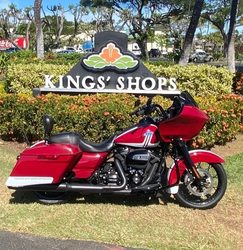 Red Road Glide motorcycle parked with ocean background