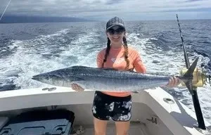 Fishermen casting lines from 31-foot Innovator boat at sunset