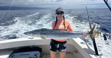 Fishermen casting lines from 31-foot Innovator boat at sunset