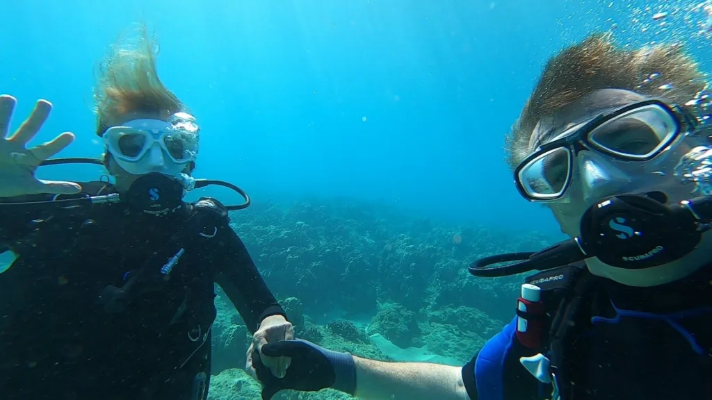 Scuba diver exploring vibrant coral reefs underwater
