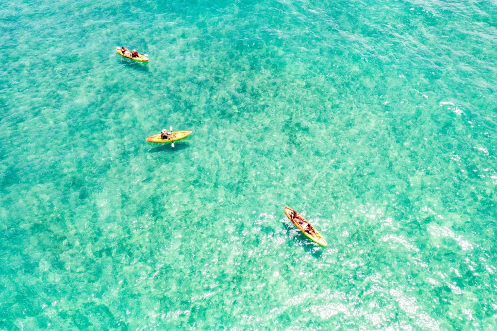 Kayaker paddling along East Oahu coastline