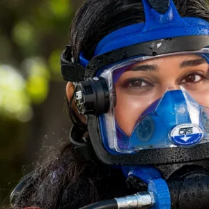 Person wearing full face snorkeling mask in clear water