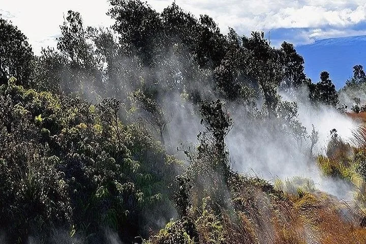 Helicopter flying over Hawaii volcano landscape