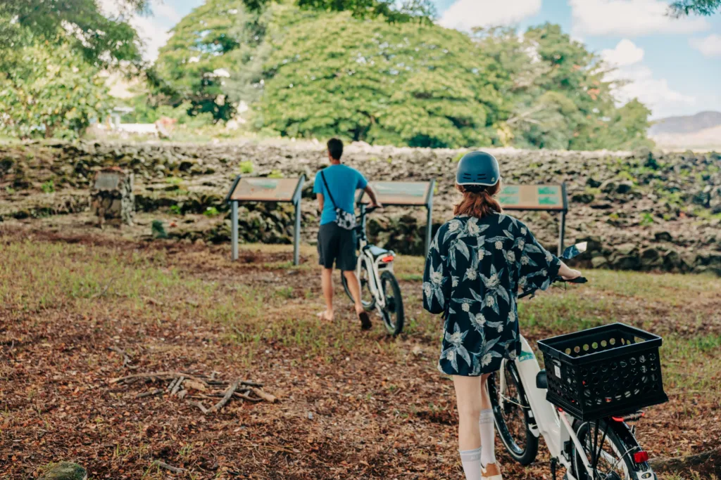 Cyclists riding e-bikes along scenic trails in Kailua on a food tour