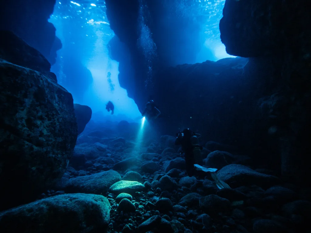 Experienced divers exploring underwater on two tanks