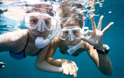 Beginner snorkelers practicing skills in calm swimming pool