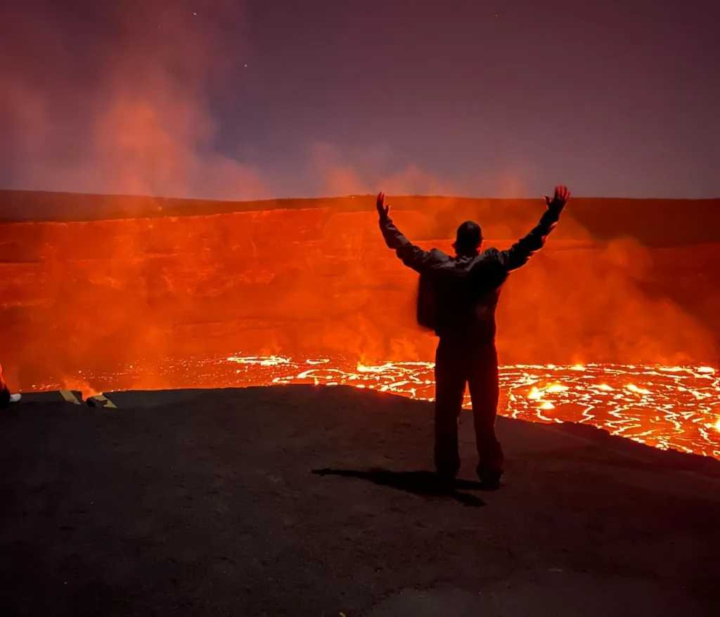 Hikers trekking volcanic landscape on Madam Pele’s trail