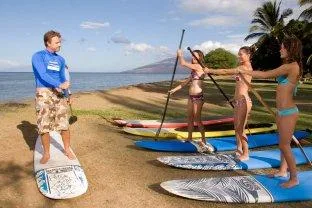 Person balancing on stand-up paddleboard near Waikiki beach