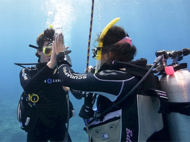 Instructor guiding student during PADI pool dive session