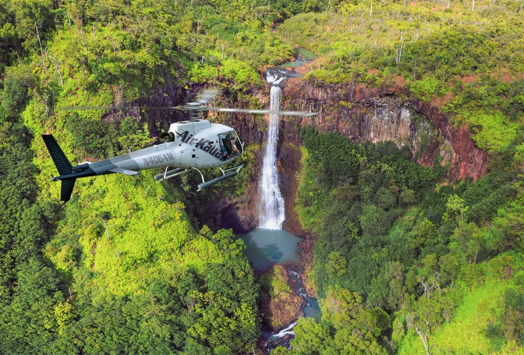Helicopter flying doors off over Kauai lush landscape
